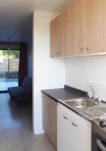 a kitchen with a sink and a counter top at Piedra Mar in El Quisco