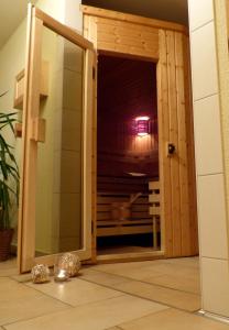 una puerta corredera de cristal que conduce a una habitación con ducha en Ferienhotel Wolfsmühle, en Rodishain