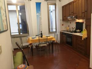 a kitchen with a table with a yellow table cloth at Lovely Irnerio ❤ flat near S. Pietro ★ in Rome