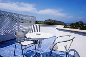 a table and chairs on a balcony with a table at Bristol Hotel in Ischia