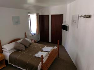 a bedroom with a large bed and a window at The Old Piggeries in Gulval