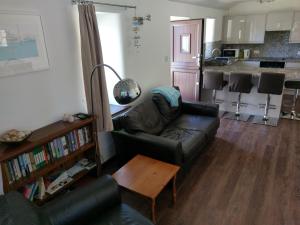 a living room with a couch and a table at The Old Piggeries in Gulval