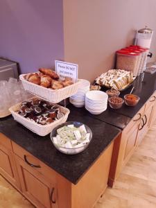 a counter with several baskets of different types of pastries at Carousel Hotel in Blackpool