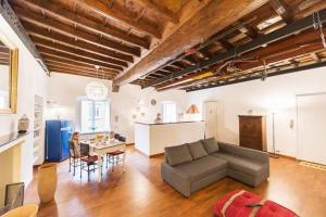 a large living room with a couch and a kitchen at La Barca di Armida in Turin