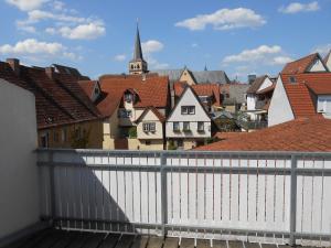 a view from the balcony of a town with a white fence at Main(schlaf)erlebnis in Karlstadt