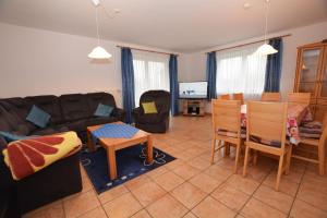 a living room with a couch and a table at Haus Sonja in Büsum