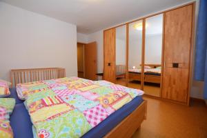 a bedroom with a bed and a mirror at Haus Sonja in Büsum
