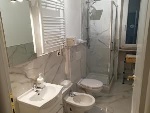 a bathroom with a sink and a toilet and a shower at B&B Casa Nizza in Turin