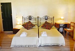 a bedroom with two beds with towels on them at Cortijo de Vega Grande in Llerena +60 photos