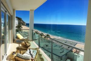 a balcony with a view of the ocean at Cali Holidays - Luxury Bed & Breakfast in Sesimbra