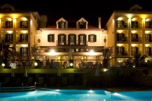 a hotel with a swimming pool at night at Hotel Quinta Bela S Tiago in Funchal