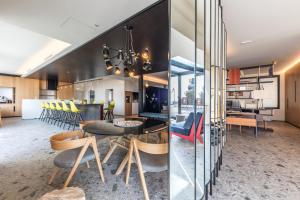 a kitchen and dining room with a table and chairs at MaisonMe Boutique Hotel in Bardolino
