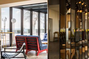 a living room with a chair and a table at MaisonMe Boutique Hotel in Bardolino