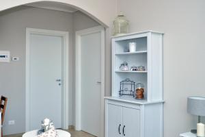 a white cabinet in a room with a lamp at IL CILIEGIO Affittacamere in Stresa