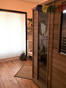 a room with a glass door to a room with a floor at La Maison du Parc in Yzeron