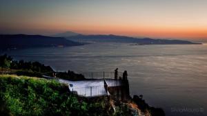two people standing on top of a hill overlooking the water at Edelweiss in Palmi