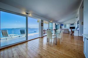 a dining room with a table and views of the ocean at Seaview Suite Lissa in Vis