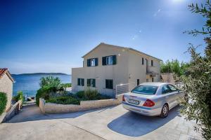 a car parked in a driveway in front of a house at Seaview Suite Lissa in Vis