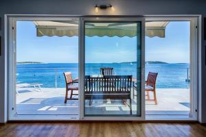 a dining room with a view of the ocean at Seaview Suite Lissa in Vis