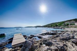 a dock on the shore of a body of water at Seaview Suite Lissa in Vis