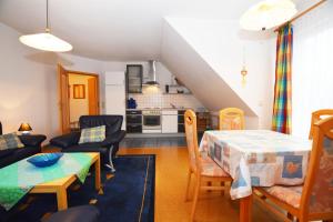 a living room with a table and a kitchen at Haus Sonja in Büsum