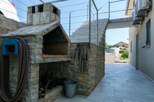 an outdoor pizza oven in a patio of a house at Seaview Suite Lissa in Vis