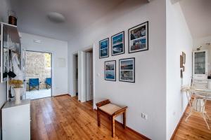 a living room with white walls and wooden floors at Seaview Suite Lissa in Vis