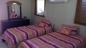 Кровать или кровати в номере Shalpa surf villa