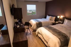 Voodi või voodid majutusasutuse Lithio Hotel toas