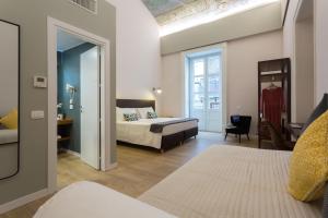 Una cama o camas en una habitación de Bellaroto Suite & SPA