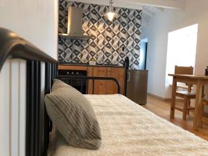 a bedroom with a bed with a pillow on it at Casa Avó Amélia in Madalena