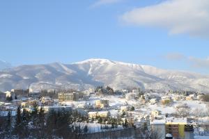 a city covered in snow with mountains in the background at Il Mulino in Guardiagrele