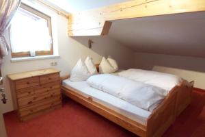 a bedroom with a large bed and a window at Gästehaus Kübler in Haus im Ennstal