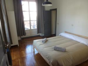 a bedroom with a large bed with two towels on it at Hostal del Arquitecto in Vitoria-Gasteiz