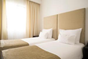 Katil atau katil-katil dalam bilik di Hotel Astoria