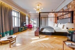 a hotel room with a bed and a tv at Grand Poet Hotel and SPA by Semarah in Riga