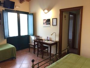 a bedroom with a desk and a bed and a room at Agriturismo Arangèa in Lequile