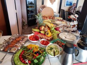 a table topped with lots of different types of food at Hotel Garni Julia in Linnich