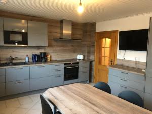 a kitchen with a wooden table and a dining room at FeWo 01 Bettenhausen in Morschen