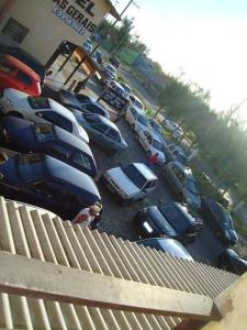 a bunch of cars parked in a parking lot at Pousada Minas Gerais in Tramandaí