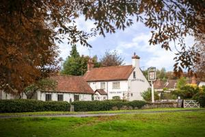 a white building with a red roof at French Horn Chalets in Alton