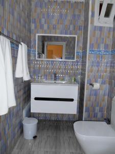 a bathroom with a sink and a mirror at Hôtel Mansour in Dakhla