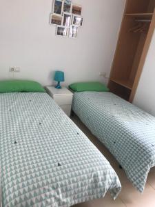 Łóżko lub łóżka w pokoju w obiekcie Ílios Apartamentos