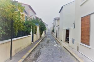 an empty street in an alley between buildings at La Maison Rouge in Paris +14 photos