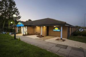 a building with a sign on the side of it at Days Inn Sutton Scotney North in Sutton Scotney