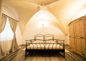 a bedroom with a bed with a coffered ceiling at Gothic Apartment in Braşov