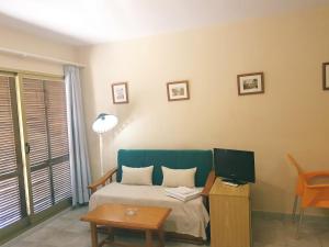 Łóżko lub łóżka w pokoju w obiekcie Apartamentos Olympia Garden