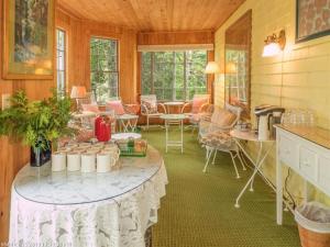 a room with a table and chairs in a room at Harbourside Inn in Northeast Harbor