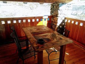 a wooden table and chairs on a wooden deck at Appartamento Sole in Morgex