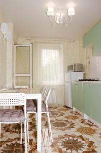 a kitchen with a table and chairs and a refrigerator at Апартаменты посуточно in Sevastopol